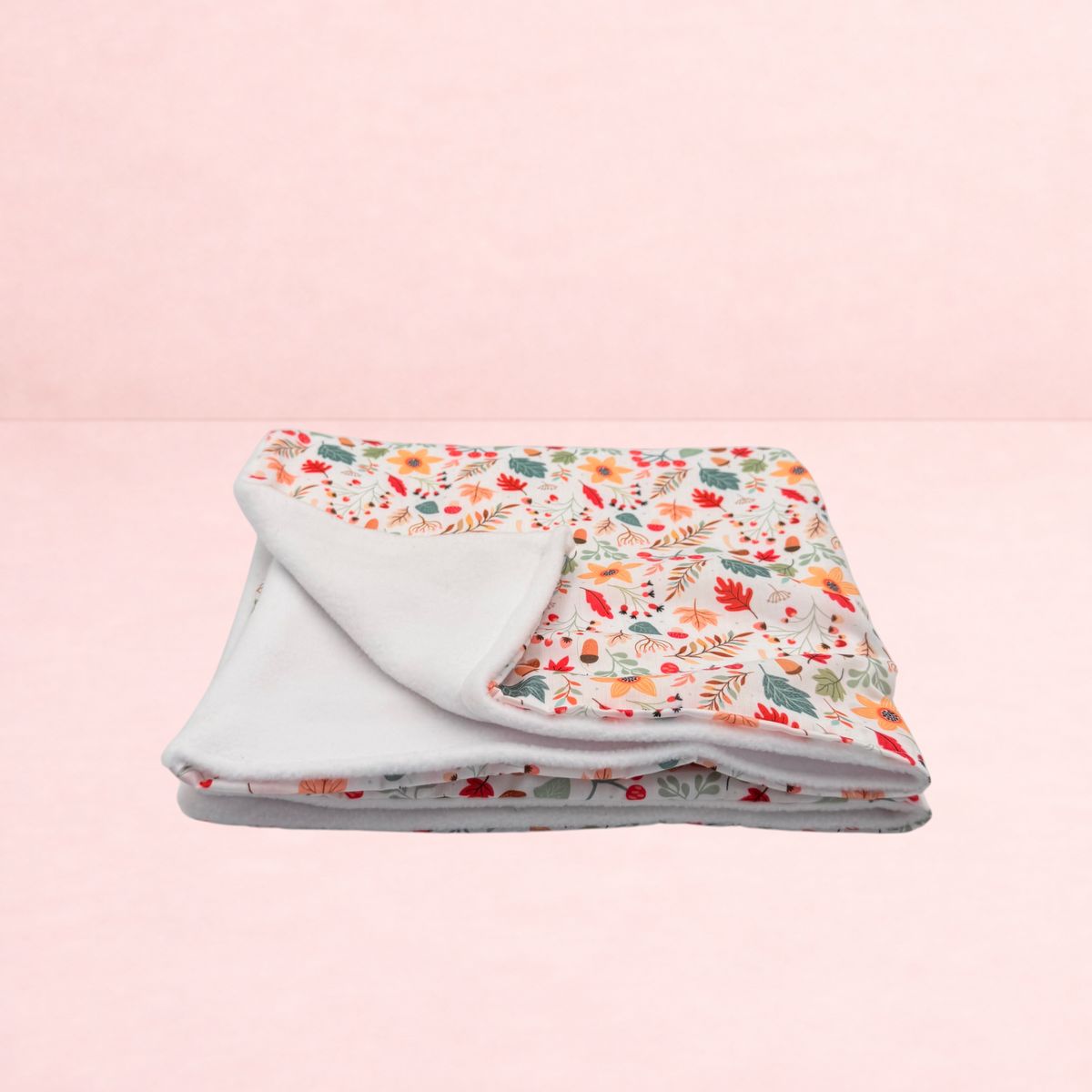 Darling Bun Shop handmade small pet blanket featuring a white background with an acorns and oak leaves floral print.