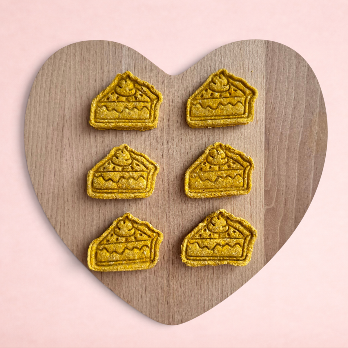 Darling Bun Shop handmade pumpkin pie oat treats for rabbits shaped like small slices of pie on a heart board