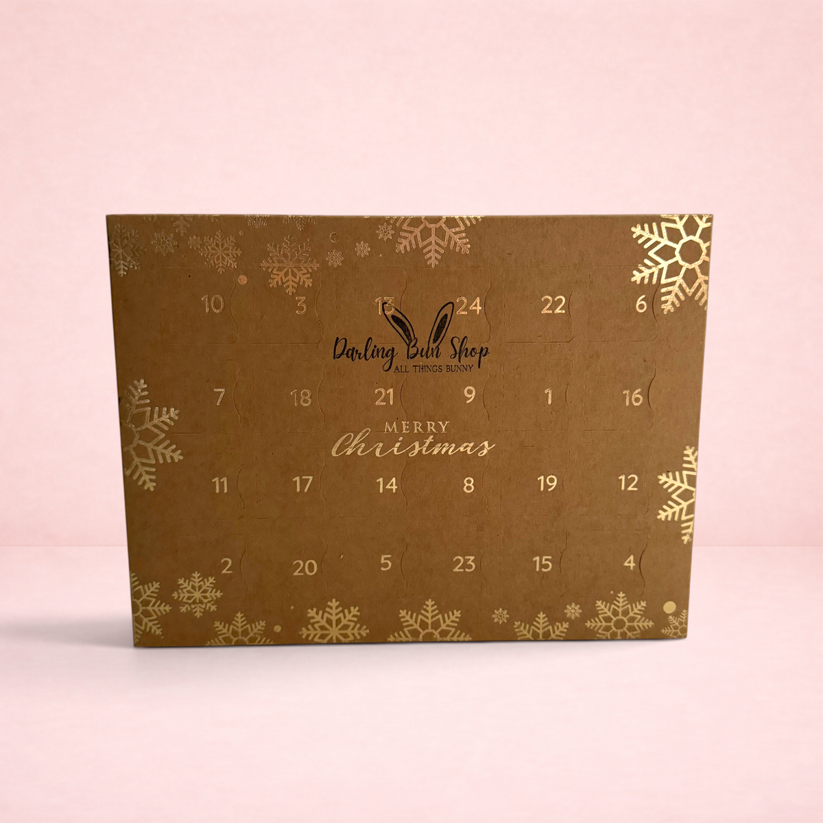 Darling Bun Shop 24 day oat treat advent calendar for small pets featuring gold snowflake designs on brown card