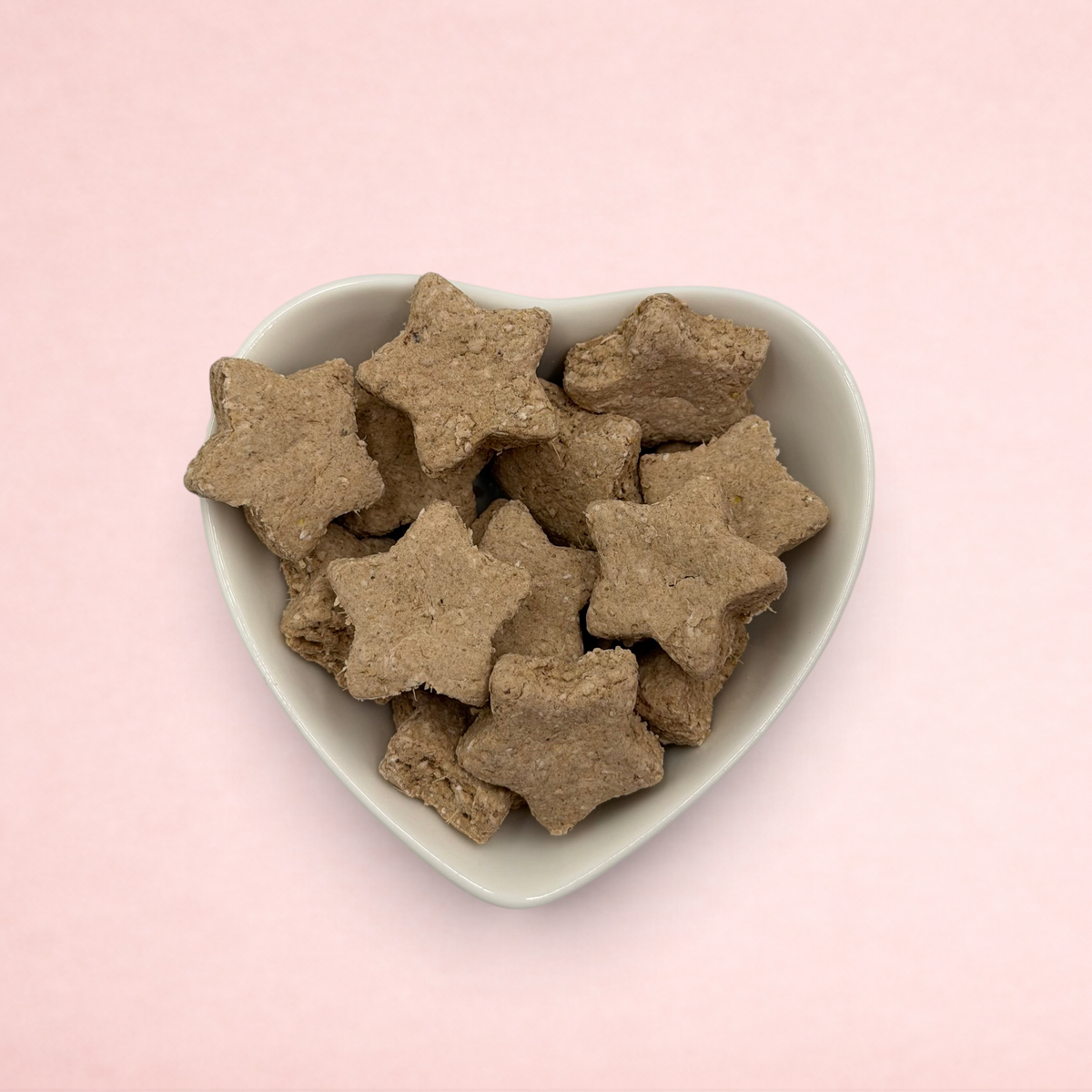 Darling Bun Shop calming banana and lavender oat star treats served in a white heart-shaped bowl.