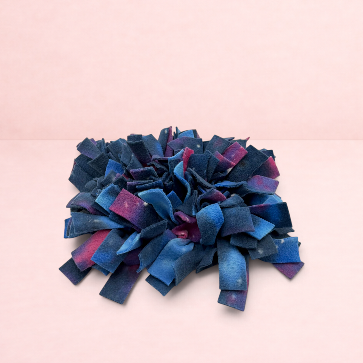 Darling Bun Shop galaxy-themed fleece snuffle mat for small animal foraging and enrichment on a pink background