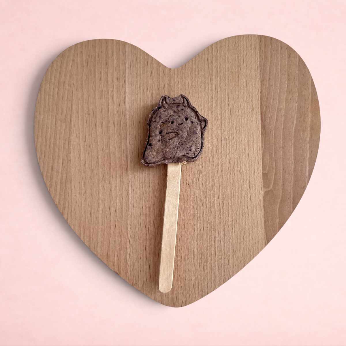 Darling Bun Shop handmade blueberry ghost lolly treat for small pets on a wooden heart-shaped board