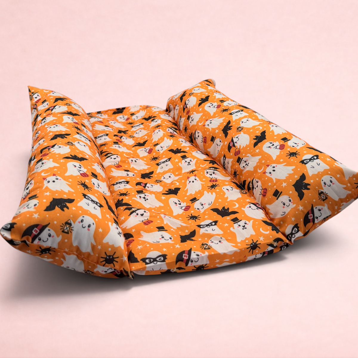 Darling Bun Shop orange Halloween ghost print snuggle and flop rabbit bed with raised pillow sides for comfort.
