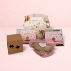 Darling Bun Shop woodland gift box containing autumn-themed rabbit treats, forage blend, and a leaf-cutout toy