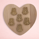Darling Bun Shop handmade banana and oat ghost bunny Halloween treats for small animals on a wooden heart board.