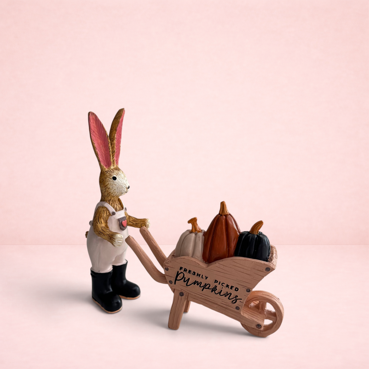 Darling Bun Shop handmade bunny ornament wearing overalls and boots, pushing a wheelbarrow filled with mini pumpkins.