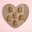 Darling Bun Shop handmade ghost-shaped oat and apple treats for rabbits and small animals on a heart-shaped board