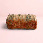 Darling Bun Shop hay bale treat for small pets, topped with dried pumpkin and carrot pieces for digestive health.