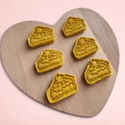 Darling Bun Shop handmade pumpkin pie oat treats for rabbits shaped like small pie slices on a heart-shaped board