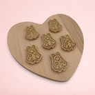 Darling Bun Shop handmade oat and banana ghost bunny Halloween treats for small animals on a wooden heart board