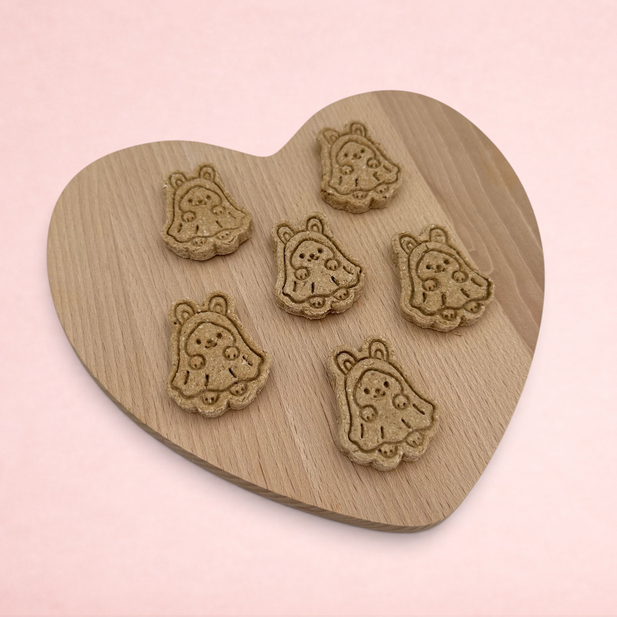 Darling Bun Shop handmade oat and banana ghost bunny Halloween treats for small animals on a wooden heart board