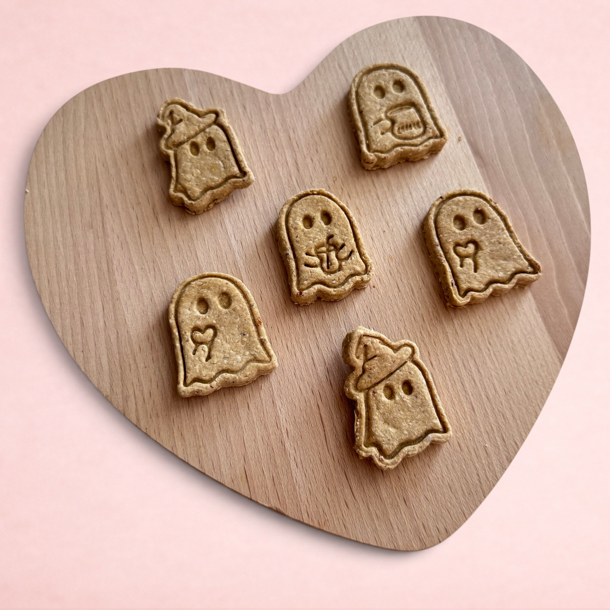 Darling Bun Shop handmade ghost-shaped oat and apple treats for rabbits and small animals on a wooden board