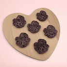 Darling Bun Shop handmade blueberry and oat bunny-shaped Halloween treats for small animals on a heart-shaped board.