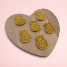 Darling Bun Shop handmade pumpkin bunny oat treats for small animals on a heart-shaped wooden board