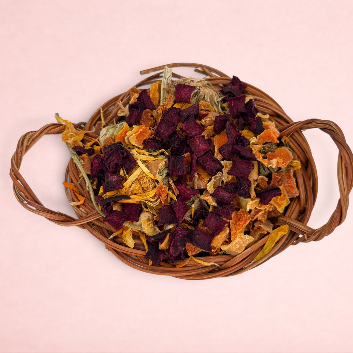 Darling Bun Shop natural vine trick-or-treat basket filled with dried beetroot, pumpkin, and marigold for rabbits.