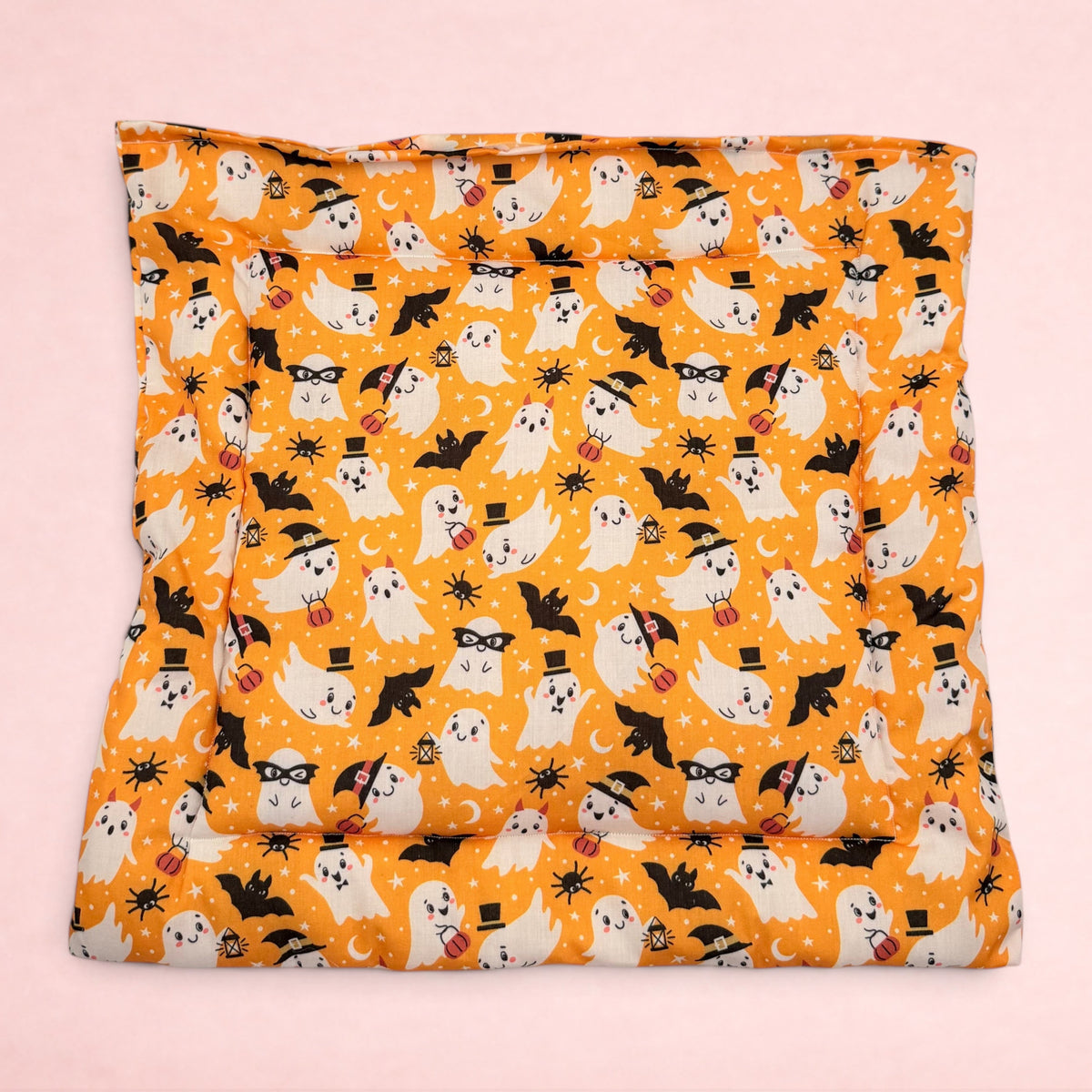 Darling Bun Shop handmade orange Halloween cushion featuring cute ghosts, bats, and pumpkins for small pets.