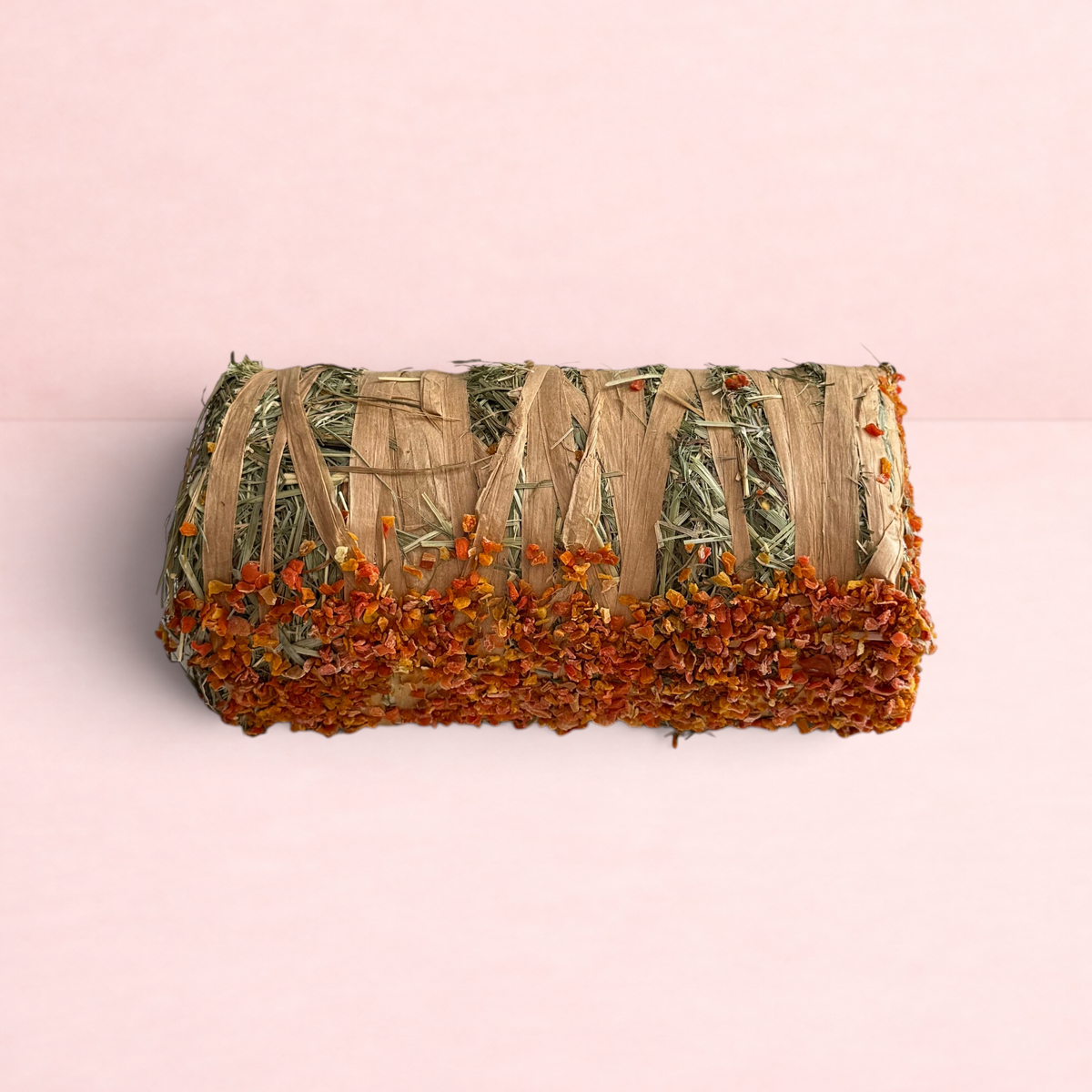 Darling Bun Shop hay bale treat for small pets, featuring dried pumpkin and carrot pieces for digestive health.