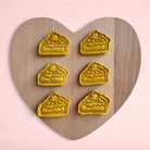 Darling Bun Shop handmade pumpkin pie oat treats for rabbits shaped like small slices of pie on a heart board