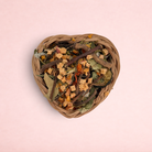 Darling Bun Shop heart-shaped natural vine basket filled with dried forage, apple, and pumpkin treats for rabbits.