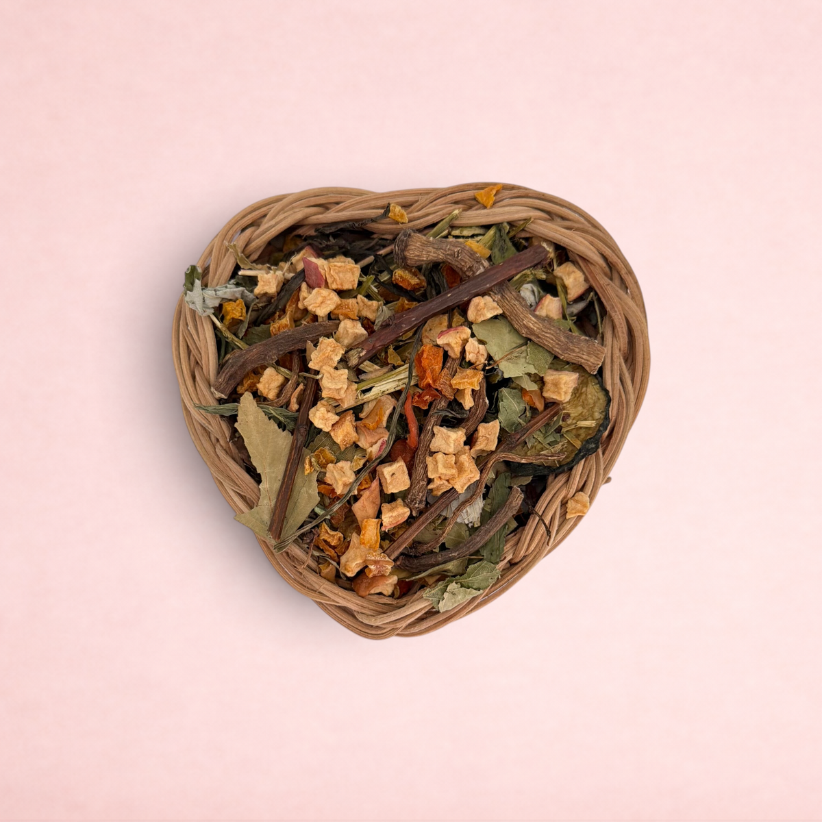 Darling Bun Shop heart-shaped natural vine basket filled with dried forage, apple, and pumpkin treats for rabbits.