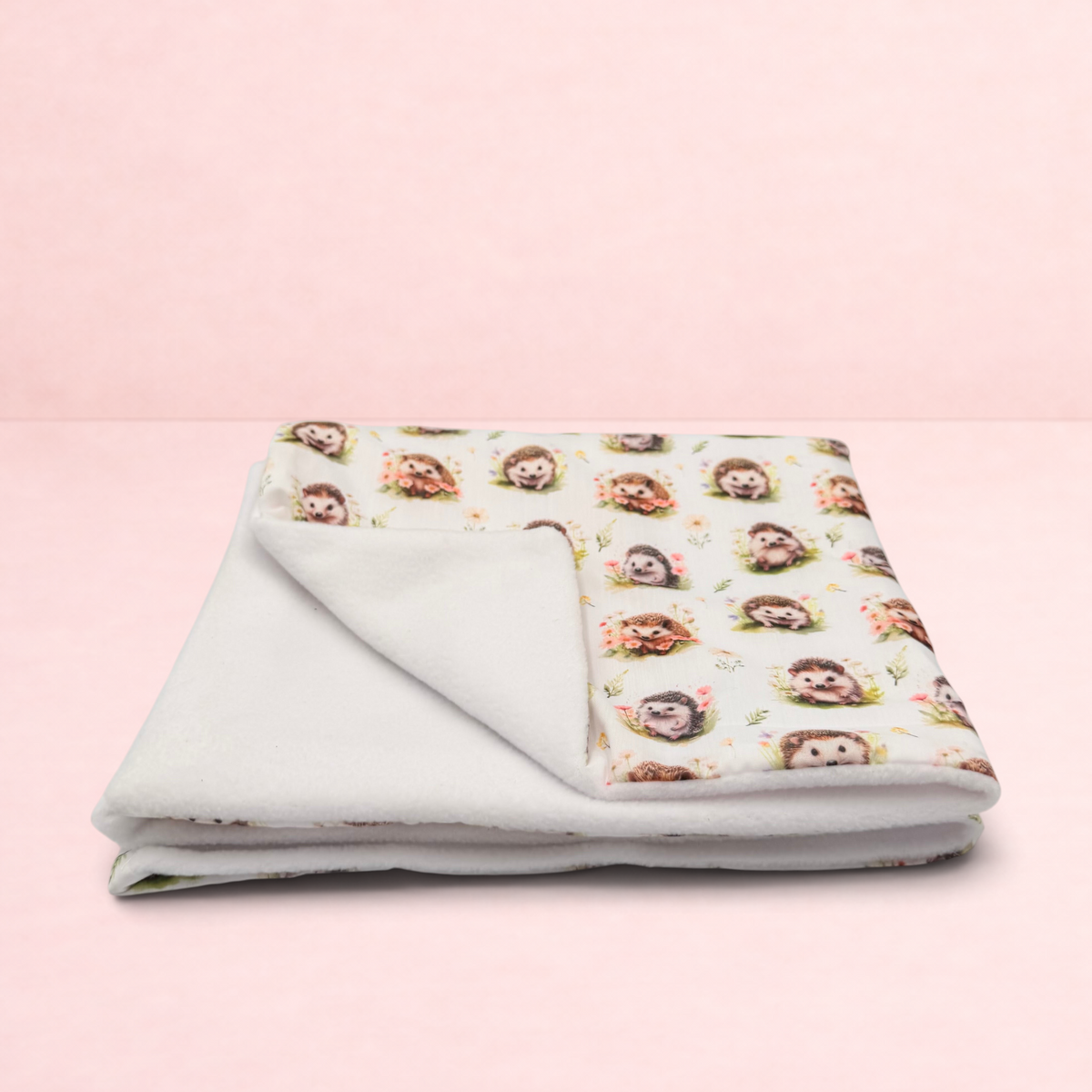 Darling Bun Shop handmade small pet blanket with an autumnal hedgehog print and soft white fleece lining.