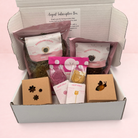 Darling Bun Shop August subscription box for rabbits containing natural treats, dried flowers, and boredom breakers.