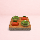 Darling Bun Shop wooden veg patch puzzle toy with colourful vegetable-shaped treat hiding domes for rabbit foraging.