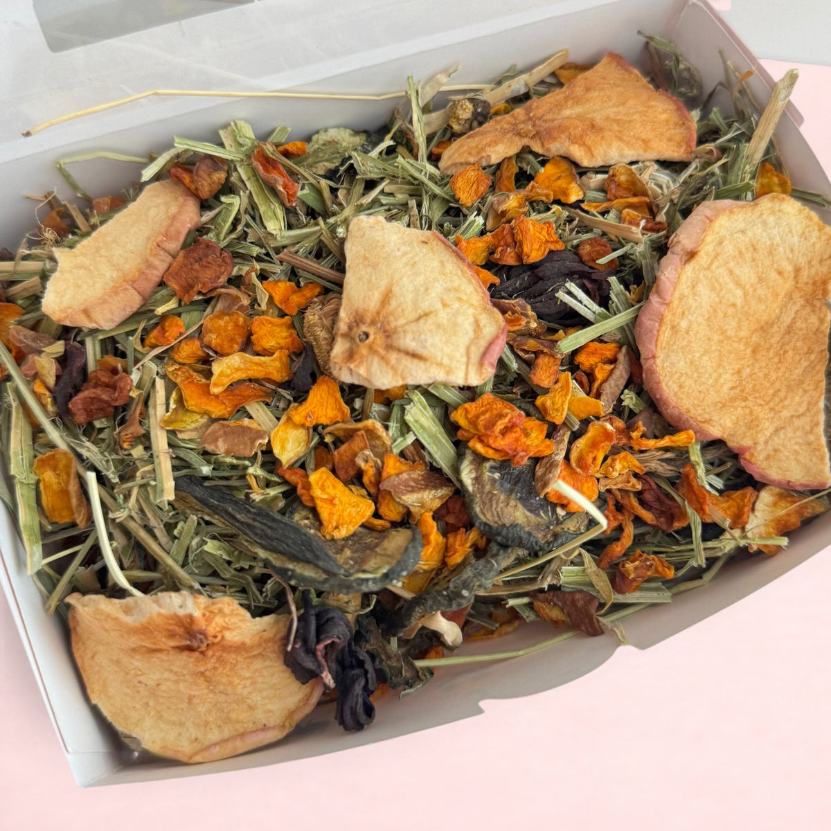 Darling Bun Shop Halloween forage box with timothy hay, dried pumpkin, and apple slices for small pets