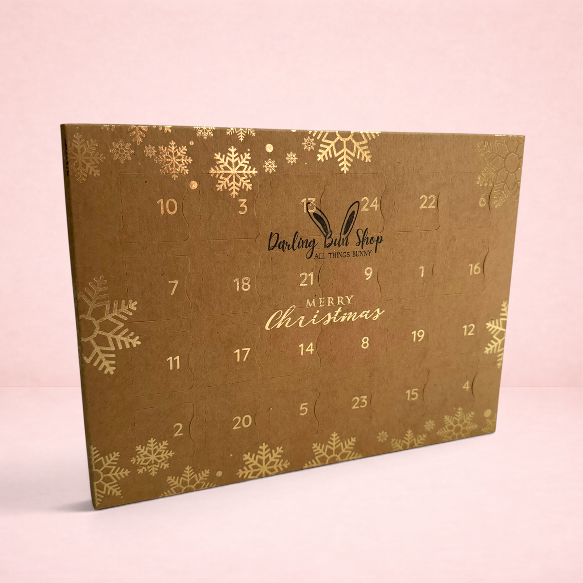 Darling Bun Shop 24 day oat treat advent calendar for small pets featuring festive gold snowflake designs on brown card