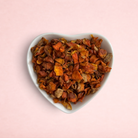 Darling Bun Shop Pumpkin Nibbles, 100% natural dried orange pumpkin treat pieces in a white heart-shaped bowl