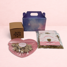 Darling Bun Shop Calming Bonfire Box with star-shaped treats, chamomile flowers, and a firework-themed boredom breaker.