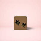 Darling Bun Shop cardboard foraging box with leaf-shaped cutouts filled with dried herbs for small pets