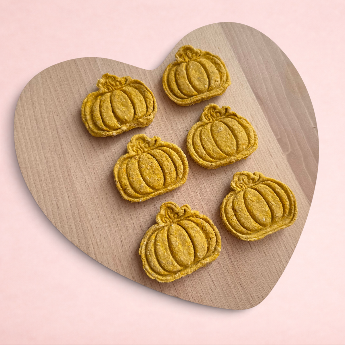 Darling Bun Shop handmade pumpkin-shaped oat and butternut squash treats for small animals on a wooden board
