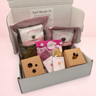 Darling Bun Shop August subscription box for rabbits containing dried flowers, herbal treats, and boredom breakers.
