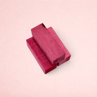 Darling Bun Shop blackberry-infused balsa wood chew blocks for small pets, featuring a dark pink stained finish.
