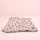 Darling Bun Shop handmade pet cushion featuring a cream fabric with a colourful pattern of acorns and oak leaves.