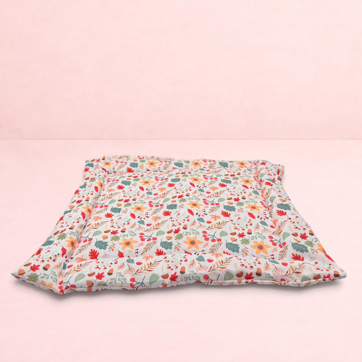 Darling Bun Shop handmade pet cushion featuring a cream fabric with a colourful pattern of acorns and oak leaves.