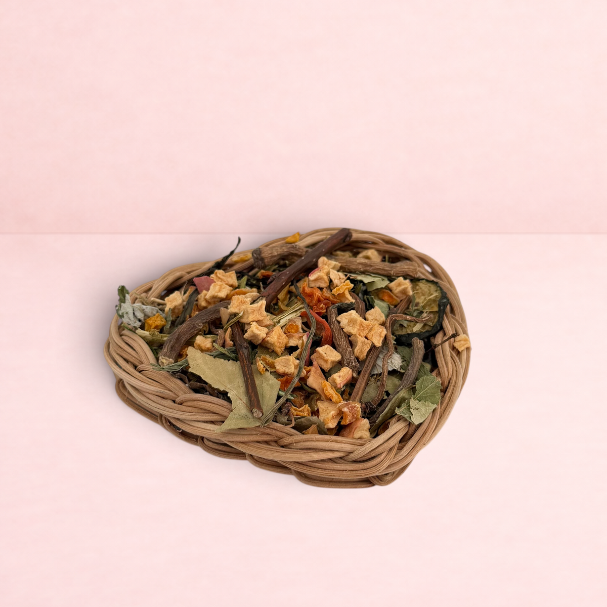 Darling Bun Shop heart-shaped natural vine basket filled with dried forage, apple, and pumpkin treats for rabbits.