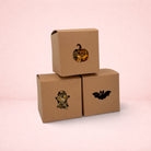 Darling Bun Shop Halloween boredom breaker boxes with pumpkin, ghost, and bat cut-outs filled with dried forage.