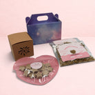 Darling Bun Shop Calming Bonfire Box with star treats, chamomile flowers, and a firework-themed boredom breaker.