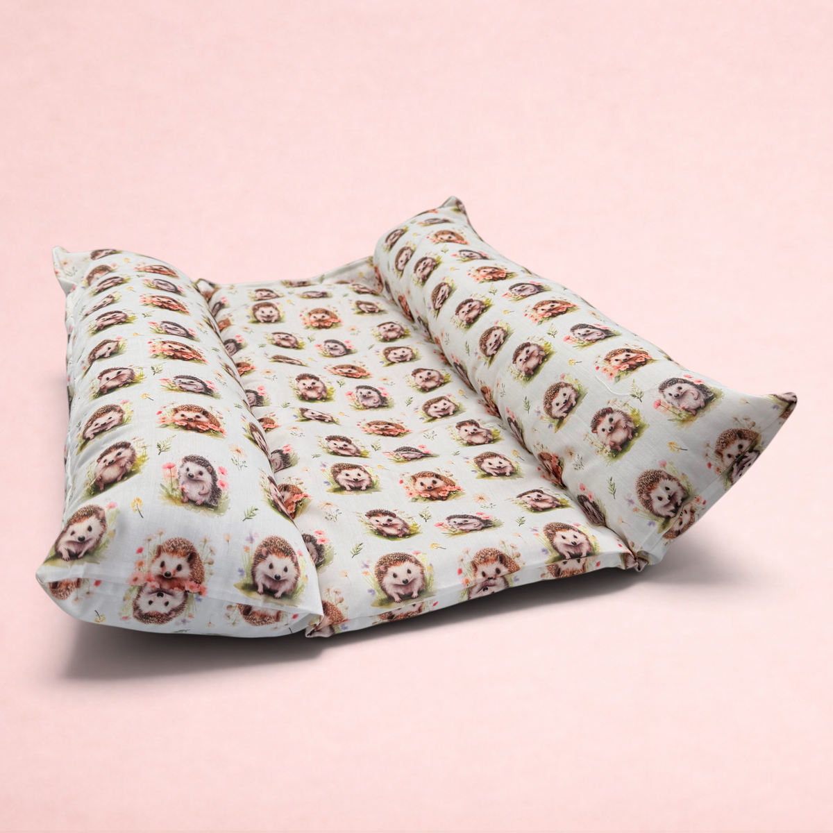 Darling Bun Shop hedgehog print snuggle and flop bed with raised pillow sides for rabbits on a white background