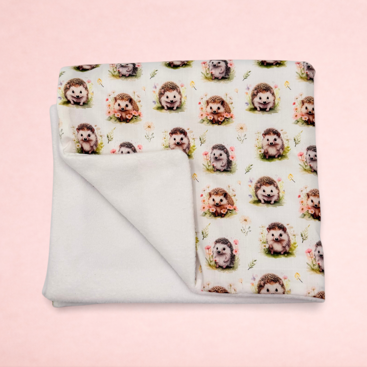 Darling Bun Shop handmade small pet blanket featuring an autumnal hedgehog pattern with a soft white fleece lining.