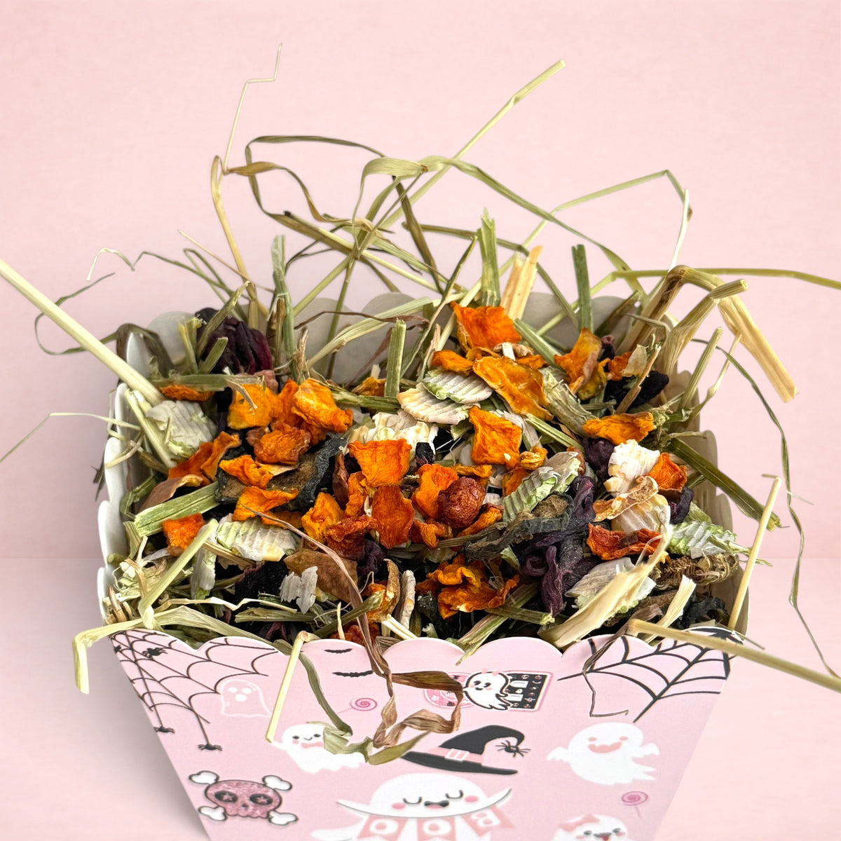 Darling Bun Shop pink Halloween snack box for small pets filled with timothy hay, pumpkin, and pea flakes.
