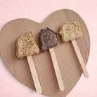 Darling Bun Shop handmade Halloween ghost-shaped rabbit treats on wooden sticks in blueberry, apple, and banana flavors
