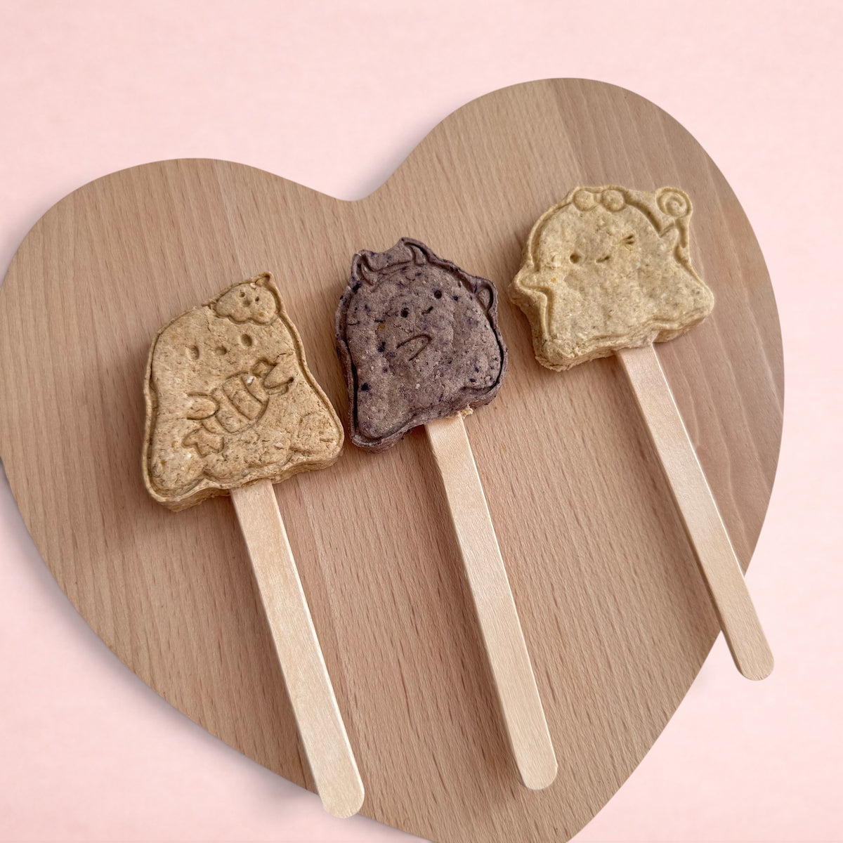 Darling Bun Shop handmade Halloween ghost-shaped rabbit treats on wooden sticks in blueberry, apple, and banana flavors