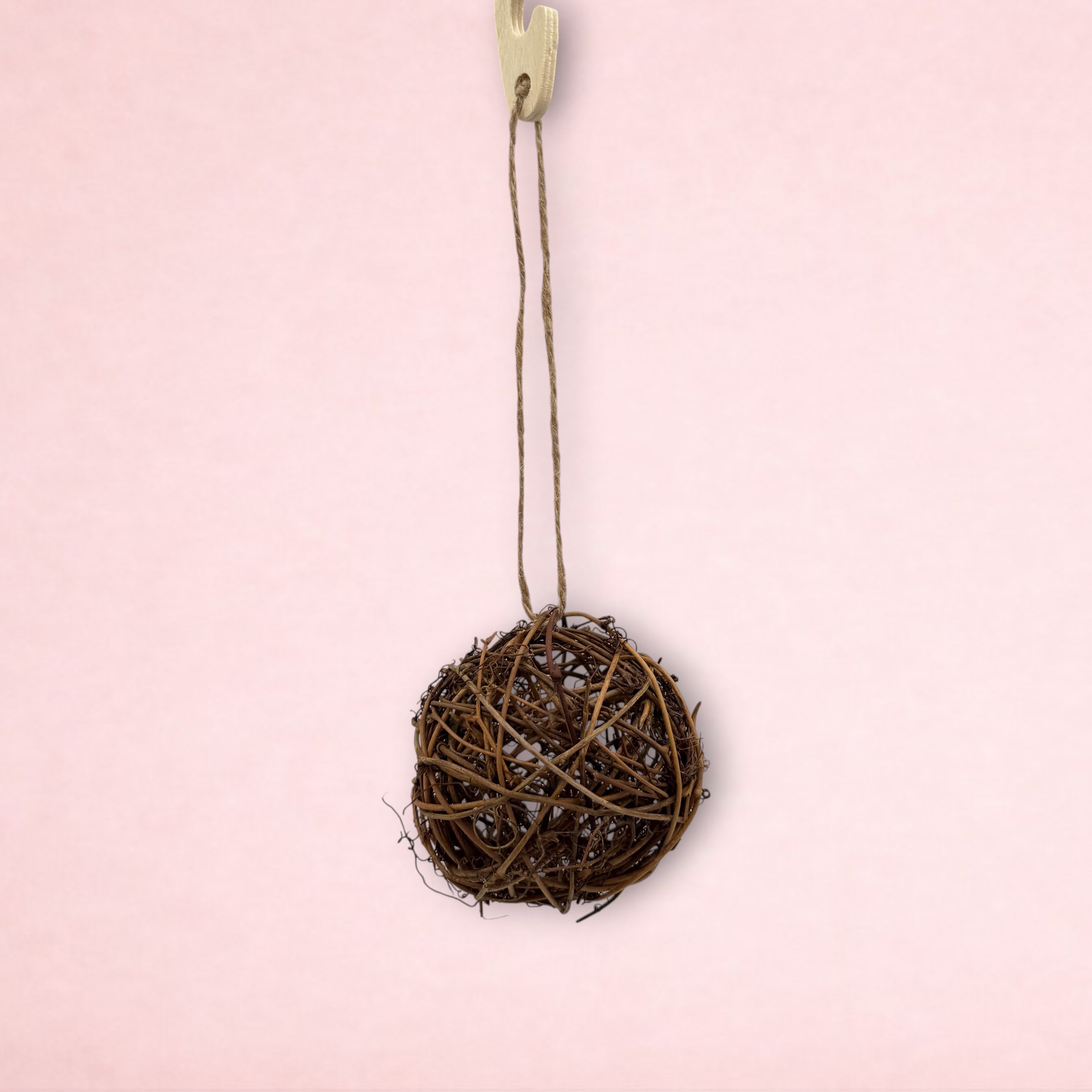 Darling Bun Shop natural willow ball toy for small animals, 9cm diameter, hanging from a wooden hook with jute twine.