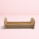 Darling Bun Shop natural wooden feeding trough for bunnies, perfect for holding hay and fresh vegetables.